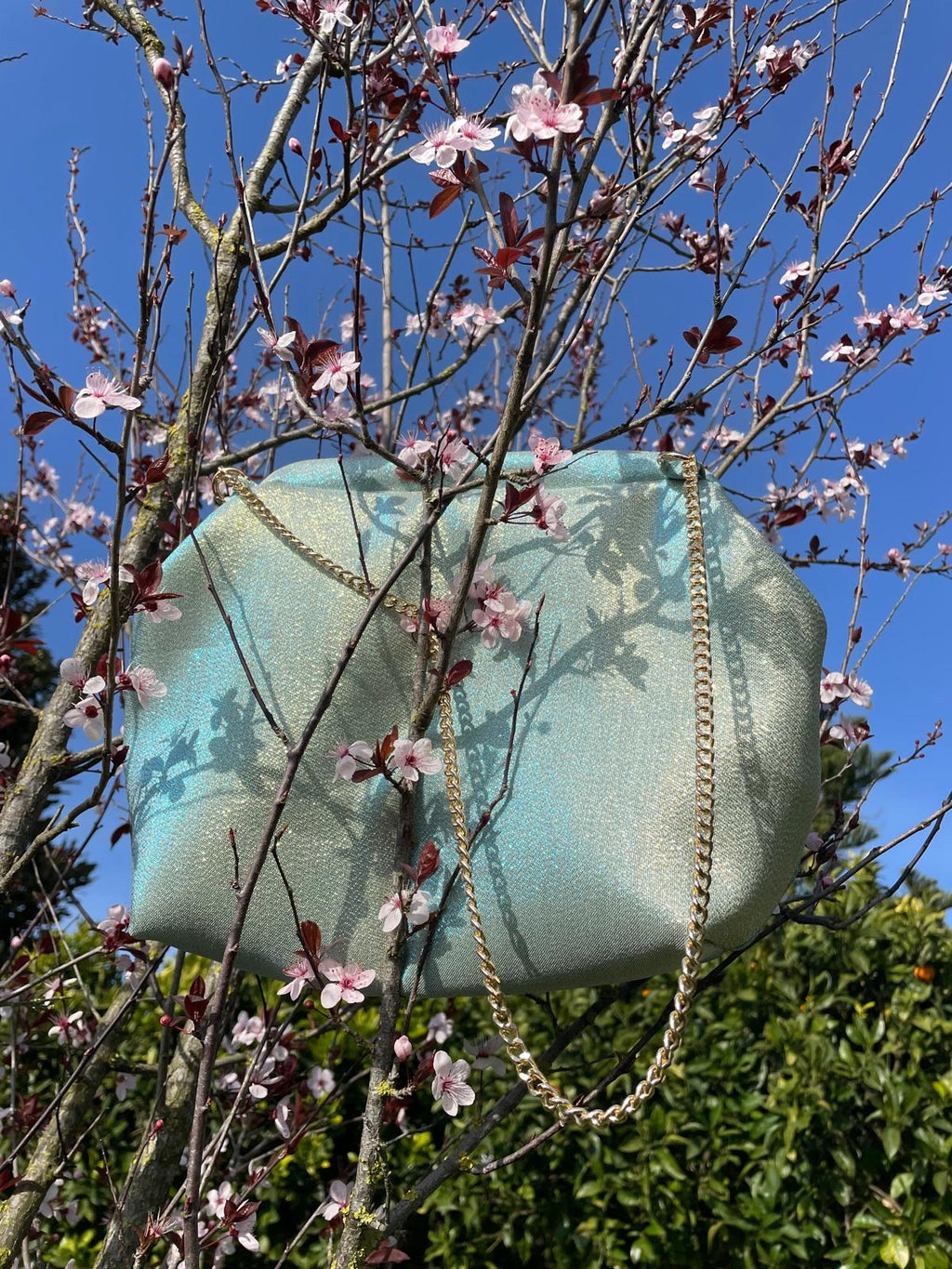 Borsa Starling in tessuto dorato cangiante con chiusura clic-clac